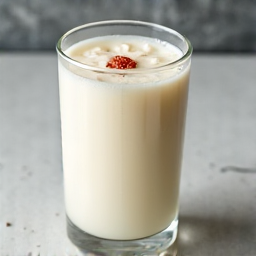 Traditional Armenian Tan yogurt drink, a refreshing accompaniment to meals, served in a glass with ice. A perfect digestive drink with a salty and tangy flavor, complementing rich Armenian and Georgian cuisine.